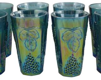 698 - 8 Indiana Blue Harvest Grape Tumblers (Description): A set of eight vintage Indiana Glass Electric  Blue Harvest Grape pattern carnival glass  tumblers. Each tumbler features the classic  raised grape and leaf motif characteristic of  this popular mid-century pattern. The iridescent carnival glass finish displays  beautiful blue, purple, and golden rainbow  hues typical of this collectible glassware.