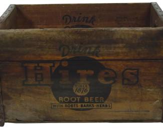 952 - Vintage Hires Root Beer Crate 10"x18"x12" (Description): Vintage Hires Root Beer wooden crate  featuring the classic "Drink Hires" logo with  "Since 1876" medallion and "With  Roots-Barks-Herbs" tagline. The crate is  constructed of natural wood with metal corner reinforcements and shows authentic age anina  consistent with its vintage origins.  Measures 10 inches by 18 inches by 12 inches.