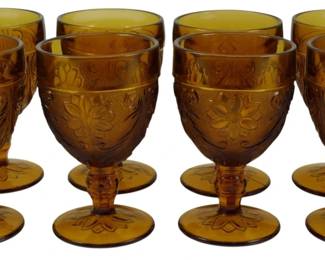 1070 - 4 Vtg Indiana Amber Tiara Sandwich Goblets (Description): Set of four vintage Indiana Glass amber Tiara  Sandwich pattern goblets. These pressed  glass goblets feature the classic Sandwich  pattern with floral and scrollwork designs in  a rich amber color. Each goblet has a footed base with matching decorativepattern.  Measures 5.5" tall.