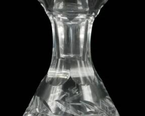 907 - Waterford Crystal Shannon Decanter 8" (Description): Waterford Crystal Shannon decanter featuring  elegant cut crystal design with a diamond and  fan pattern on the bulbous body. The  decanter has a graceful tapered neck with  ring detail and comes with a matching faceted stopper. Measures 8 inches tall.
