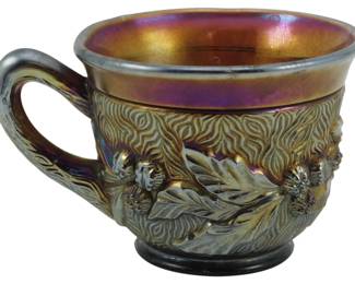 719 - Northwood Amethyst Acorn Burrs Carnival Cup (Description): Vintage Northwood amethyst carnival glass cup  in the Acorn Burrs pattern. This pressed  glass piece features a richly detailed design  of oak leaves and acorns against a textured  bark-like background. The interior displays the characteristic iridescent finish with  golden and purple hues typical of quality  carnival glass. Measures 2.5 inches.