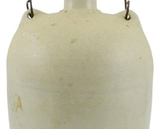 1004 - Vintage Glazed Stoneware Crock Jug w/ Handle (Description): Vintage glazed stoneware crock jug featuring  a cream-colored salt glaze finish. The jug  has a classic rounded body with a narrow neck  and spout, fitted with a wire bail handle  with a turned wooden grip. Measures 9 inches tall.