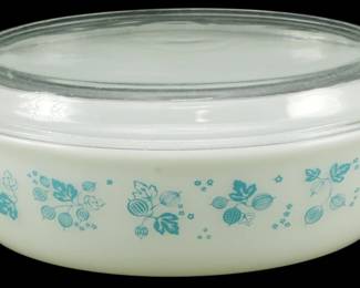 1168 - Pyrex Blue Gooseberry Large Casserole w/ Lid (Description): Pyrex Blue Gooseberry large casserole dish  with clear glass lid. The white milk glass  casserole features the classic turquoise blue  gooseberry pattern with decorative berries,  leaves, and small floral accents. Measures 5 inches high by 13 inches long by 8 inches  wide.