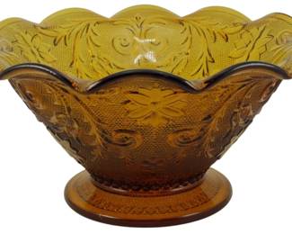 1065 - Vtg Indiana Amber Ruffled Console Bowl (Description): Vintage Indiana Glass amber ruffled console  bowl featuring a pressed glass design with  scrolling foliage and floral motifs. The bowl  displays a scalloped ruffled rim and sits on  a round pedestal base. The warm amber coloring and intricate pattern are  characteristic of Indiana Glass Company's  decorative wares. Measures 5 inches tall by  10 inches in diameter.
