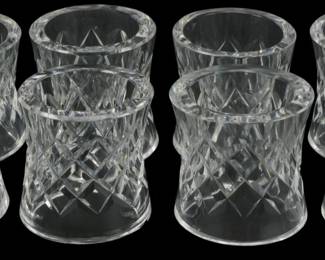 909 - 8 Waterford Crystal Napkin Rings 2" (Description): Set of eight Waterford crystal napkin rings  featuring a classic diamond cut pattern with  crosshatch design. The rings showcase the  brilliant clarity and precision cutting  characteristic of Waterford crystal, with a smooth polished rim and decorative faceted  body. Each ring measures 2 inches.