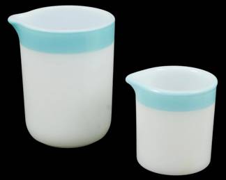 1108 - Vtg Pyrex Set of 2 Turquoise Creamers 3" (Description): Vintage Pyrex set of two creamers in white  milk glass with turquoise banding at the rim.  Each creamer features a pour spout. The  smaller creamer measures 3 inches in height.