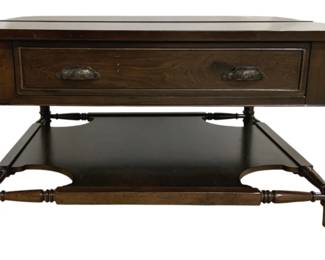 7734 - Lift Top Coffee Table w/ Lower Shelf (Description): Lift top coffee table featuring a single  drawer with decorative metal drop pulls. The  table has turned legs connected by stretchers  supporting a lower shelf. Constructed of  dark-stained wood with a traditional style. Measures 21" x 42" x 42".
