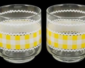 1157 - Set of 4 Libbey Yellow Gingham Glasses 3.5" (Description): Set of four Libbey drinking glasses featuring  a cheerful yellow and white gingham check  pattern around the center. The gingham band  is bordered by white rickrack-style trim at  the top and bottom edges. These vintage roly poly style glasses have a rounded shape with  a slightly weighted base. Each glass measures  3.5 inches tall.