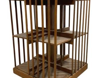 7786 - Antique English Revolving Bookcase (Description): Featuring two tiers of book storage with  slatted spindle sides on all four sections.  The piece has a molded top edge and rests on  caster wheels for easy mobility. This classic  Victorian-style rotating bookstand measures 34 inches tall by 22 inches wide by 22 inches  deep.