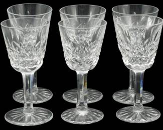 911 - 6 Waterford Crystal Cordial Glasses 3.5" (Description): Set of six Waterford crystal cordial glasses  featuring the classic Lismore pattern. Each  glass displays the distinctive diamond and  wedge cuts characteristic of Waterford's  finest craftsmanship, with a multi-sided stem and starburst cut base. Each glass measures  3.5 inches tall.