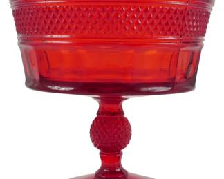 759 - Vintage Viking Ruby Glass Compote 6"x6" (Description): Vintage Viking ruby glass compote featuring a  striking deep red color throughout. The bowl  displays a diamond point pattern band around  the upper rim with paneled sides below. The  pedestal stem features a hobnail-style ball knob and rests on a circular foot. Measures 6  inches in diameter by 6 inches tall.