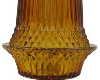1066 - Vtg Indiana Amber Diamond Point Fairy Lamp (Description): Vintage Indiana Glass amber Diamond Point  fairy lamp. This two-piece pressed glass  candle lamp features the classic Diamond  Point pattern with vertical ribbing and a  diamond-cut design. The lamp includes a footed base and removable shade in a rich  amber color. Measures 6.5 inches tall.