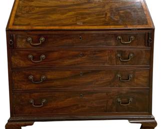 7749 - English Banded Inlaid Slant Front Secretary (Description): Antique mahogany slant front secretary desk  featuring beautiful flame mahogany veneers  with satinwood crossbanding on the fall  front. The desk is fitted with four graduated  drawers, each with brass bail handles and escutcheons. The piece rests on ogee bracket  feet in the Chippendale style. The slant  front opens to reveal interior compartments  for writing and storage. Measures 43" high x  42" wide x 22" deep.