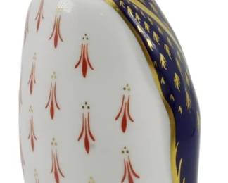 790 - Royal Crown Derby Penguin Paperweight Gold (Description): Royal Crown Derby penguin paperweight  featuring the classic Imari color palette of  cobalt blue, iron red, and 22-karat gold. The  penguin stands with head raised, decorated  with deep blue wings and head accented by gilded details, while the white breast  displays the traditional red and gold floral  pattern. Includes the gold stopper indicating  a first-quality piece. Measures 5.5 inches  tall.