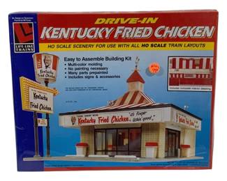 1646 - Life-Like HO Scale KFC Drive-In Building Kit (Description): Life-Like 16-piece HO scale building kit  featuring a Kentucky Fried Chicken drive-in  restaurant. This easy to assemble building  kit is designed for use with all HO scale  train layouts. The kit features multi-color molding with many parts repainted, requiring  no additional painting. Includes signs and  accessories with complete interior detailing.  The classic drive-in design captures the  nostalgic Colonel Sanders' Recipe Kentucky