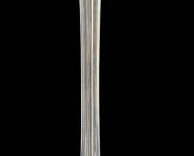 1427 - Glass Swung Floor Vase 39" (Description): A striking glass swung floor vase featuring  an elegant elongated trumpet form with  vertical ribbing along the body. The vase  rises from a distinctive footed base with  graceful curved feet. Measures 39 inches tall.