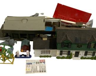 1710 - Lot HO Scale Model Train Buildings & Access (Description): Lot of HO scale model railroad items  including assembled buildings and  accessories. The collection features various  structures including a two-story residential  house with green trim and attached garage, a large commercial or industrial building with  gray siding, smaller outbuildings and sheds,  a Ferris wheel carnival ride, and various  scenic accessories. Also includes sheets of  miniature decals featuring town names such as