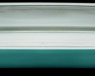 1028 - Pyrex Turquoise Casserole Dish w/ Lid (Description): Pyrex turquoise casserole dish with clear  glass lid. The dish features the classic  Pyrex turquoise coloring with a rectangular  shape and convenient side handles. Measures 3  inches tall by 12 inches long by 7 inches wide.