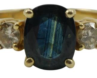 812 - 14K Gold Sapphire & Diamond Ring Size 6 (Description): 14k gold ring featuring a prong-set oval blue  sapphire center stone flanked by two round  brilliant-cut diamonds. Size 6. Weight:  0.11oz.