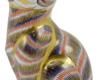 805 - Royal Crown Derby Seated Cat Paperweight (Description): Royal Crown Derby seated cat paperweight  featuring the iconic Imari pattern in rich  cobalt blue, rust red, and 22-karat gold  detailing. This charming feline figurine  displays intricate hand-painted striped decoration throughout the body with gold  accents on the ears, eyes, nose, and paws.  Includes the gold stopper on the base,  indicating a first-quality piece. Measures  5.5" tall.
