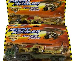 1634 - Heavy Hauler Military Force Playsets Lot of 2 (Description): Lot of two Heavy Hauler Military Force  playsets, new in original packaging. Each set  features freewheel running vehicles  including a military transport truck with  trailer carrying a Marines helicopter. Made in China. Packaging shows some wear but  contents appear intact.