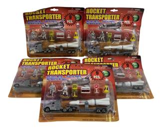 1630 - 5pc Lot Rocket Transporter Play Sets (Description): Lot of five Rocket Transporter play sets,  each containing 9 pieces. The sets feature  die cast metal and plastic parts with  authentic details, including a rocket on a  flatbed transporter truck, astronaut figures, and various road accessories. Made in China,  item no. 99550. All sets remain sealed in  original packaging.