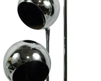 939 - Sonneman Chrome Eyeball Lamp 28" (Description): Vintage chrome table lamp featuring three  adjustable eyeball-style spherical shades  mounted on stems of varying heights. The lamp  has a mid-century modern space age design  with polished chrome finish throughout and a round base. The globe shades have black  interiors and can be positioned to direct  light as desired. Base has small dent in  edge. Measures 28 inches tall. Used as is electric/electronic/mechanical