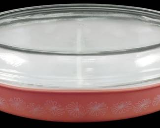 1222 - Pyrex Pink Daisy Divided Casserole w/ Lid (Description): Pyrex Pink Daisy divided casserole dish with  clear glass lid. The pink milk glass base  features a charming white daisy pattern  around the exterior. The dish includes the  original fitted glass lid with tab handles on each end. Measures 3 1/2 inches tall by 13  inches long by 8 inches wide.