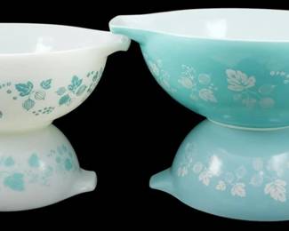 1036 - Pyrex Turquoise Gooseberry 4pc Mixing Bowls (Description): Pyrex Turquoise Blue 4-piece Gooseberry  mixing bowl set. This classic mid-century set  features the iconic Gooseberry pattern with  delicate leaf and berry motifs. Includes  nesting Cinderella-style bowls in both turquoise with white design and white with  turquoise design, featuring the signature  pour spouts and tab handles. Measures 4.5" x  13".