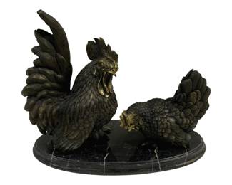 1538 - Bronze Rooster Sculpture w/ Marble Base (Description): Bronze sculpture featuring a rooster and hen  pair mounted on an oval black marble base  with white veining. The rooster stands  proudly with tail feathers raised while the  hen is depicted in a feeding pose. Both figures display finely detailed feathers with  gilt accents on the combs, wattles, and  beaks, creating an elegant contrast against  the dark patina. Measures 17 inches by 14  inches by 8 inches.