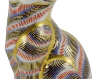 795 - Royal Crown Derby Seated Cat Paperweight (Description): Royal Crown Derby seated cat paperweight  decorated in the Imari pattern with rich  cobalt blue, iron red, and 22-karat gold  accents. The figurine features the classic  striped design with gold detailing on the eyes, nose, ears, and paws. This paperweight  does not have the gold stopper. Measures 5.5  inches tall.