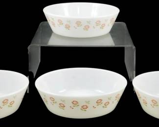 1101 - Set of 4 JAJ Pyrex Bowls Floral Pattern (Description): Set of four JAJ Pyrex bowls featuring a  charming floral pattern with pink and red  flowers and green leaves on a white milk  glass background. These vintage English Pyrex  bowls have a soft rounded square shape, ideal for cereal, desserts, or side dishes.  Each bowl measures 2 inches tall by 5.5  inches in diameter.