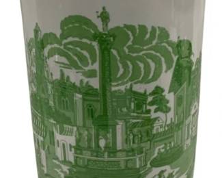 1501 - Green & White Transferware Umbrella Stand (Description): A ceramic umbrella stand featuring green and  white transferware decoration. The  cylindrical form displays scenic  European-style vignettes with classical  architectural elements, a central monument or column, figures on horseback, and pastoral  landscapes. The rim and base are adorned with  ornamental borders featuring medallions and  floral motifs. Measures 17.5 inches tall by  7.5 inches in diameter.