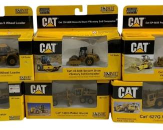 1037 - 6 Norscot 1/87 CAT Vehicles (Description): A collection of six Norscot 1/87 scale CAT  construction vehicles. Each model is packaged  in its original box featuring the  distinctive Caterpillar branding.