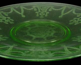 898 - Anchor Hocking Cameo Ballerina Uranium Plate (Description): Vintage Anchor Hocking Cameo Ballerina  pattern uranium glass plate in green. This  Depression-era glass plate features the  distinctive etched design with dancing  ballerina figures and decorative scrollwork around the rim. The plate exhibits the  characteristic green uranium glass  coloration. Measures 10 inches in diameter.