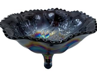 677 - Fenton Amethyst Stag & Holly Carnival Bowl (Description): Vintage Fenton amethyst Stag & Holly pattern  carnival glass footed bowl. This piece  features the classic iridescent finish  characteristic of carnival glass, with rich  purple-black coloring and rainbow iridescence visible in the pattern. The bowl displays  the distinctive Stag & Holly design with a  detailed stippled center medallion, holly  leaf motifs, and scalloped crimped rim.  Measures 4 1/2 inches tall by 9 inches in