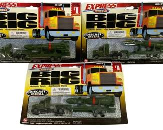 1638 - 3pc Express Wheels Big Rig Diecast Trucks (Description): Three piece lot of Express Wheels Big Rig  diecast metal trucks. Each truck is sealed in  original blister packaging and features  military-style flatbed semi-trucks carrying  MX-30 missile transporters in olive green. The packaging advertises authentic details  and fast running wheels. Made in China.