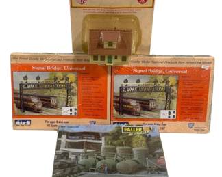 1685 - 4 pc Lot HO Scale Model Railroad Building (Description): A collection of four HO scale model railroad  building kits. The lot includes two IHC  Signal Bridge Universal kits (Stock No.  5015), one IHC small building kit (No. 907)  featuring a house structure, and one Faller Military kit (No. 144038) depicting fuel  storage tanks. All kits are in their original  packaging. Designed for ages 8 and over.