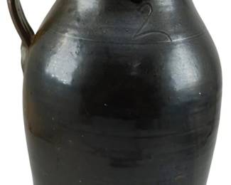629 - Antique Southern Pottery Stoneware Pitcher (Description): Antique Southern pottery stoneware pitcher  with a dark glaze finish and applied handle.  The pitcher features a traditional form with  a flared rim and pouring spout. Measures 13  inches in height.