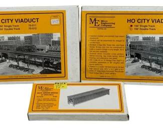 1059 - 3 Micro Engineering HO City Viaduct Kits (Description): Three Micro Engineering model railroad kits  including two HO City Viaduct sets (model  75-512, 150' Double Track) and one Deck  Girder Bridge kit. The City Viaduct kits  feature injection-molded, pre-colored, high impact styrene construction. All kits appear  to be in original packaging.