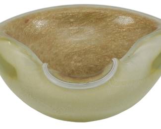 857 - Murano Beige Glass Ashtray w/ Gold Flecks (Description): Vintage beige glass ashtray featuring  aventurine gold flecks throughout the  interior. The bowl has a distinctive pinched  triangular form with softly folded edges. The  exterior displays a creamy beige coloration while the interior showcases shimmering  copper-gold inclusions characteristic of  mid-century Murano-style glasswork. Measures  2" x 6".