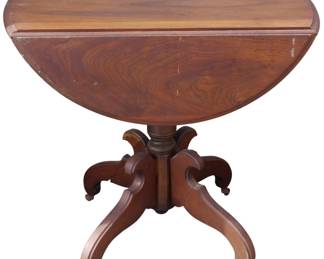 581 - Victorian Walnut Drop Leaf Table 30"x32"x36" (Description): A drop leaf table featuring a pedestal base  with four curved legs on casters. The table  measures 30 inches by 32 inches by 36 inches.