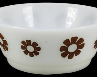1150 - Anchor Hocking Daisy Bowl 2"x5" (Description): Anchor Hocking Daisy bowl in white milk glass  featuring a charming mid-century modern  design of brown daisy flowers encircling the  exterior. The bowl has a classic rounded  shape with a slightly raised foot. Measures 2 inches tall by 5 inches in diameter.