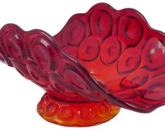 997 - L.E. Smith Amberina Moon & Stars Fruit Bowl (Description): Vintage L.E. Smith Amberina Moon & Stars  fruit bowl featuring the iconic pressed glass  pattern with circular motifs throughout. The  glass transitions from a rich ruby red at  the top to warm amber orange at the scalloped pedestal base, creating the distinctive  amberina effect. The bowl has an elegant  flared, fan-like shape with decorative  scalloped edges. Measures 5 1/2" x 11" x 7".