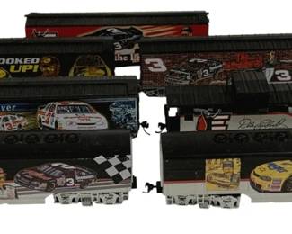 1594 - 3pc Dale Earnhardt NASCAR Train Set (Description): Three-piece Dale Earnhardt collectible train  set featuring NASCAR-themed decorations. The  set includes a locomotive and freight cars  adorned with imagery of the #3 Goodwrench  racing car, Dale Earnhardt portraits, and various racing graphics including 'Hooked  Up!' and 'Quick Silver' designs. The cars  display the iconic black and silver color  scheme associated with Earnhardt's legendary  racing career.