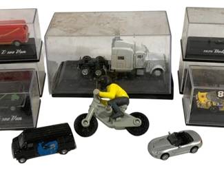 1029 - Lot Cars, Trucks & More Die Cast Vehicles (Description): A lot of cars, trucks and more die cast  vehicles. The collection includes various  model vehicles in display cases as well as  loose pieces.