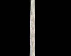 1426 - Glass Swung Floor Vase 39.5" (Description): Clear glass swung floor vase featuring  elegant vertical ribbing throughout. The  elongated trumpet-form body rises from a  flared, petal-like base with pronounced  ridges that extend upward through the slender neck to a gently flared rim. The swung glass  technique creates a graceful, stretched  silhouette characteristic of mid-century  decorative glassware. Measures 39.5 inches  tall.
