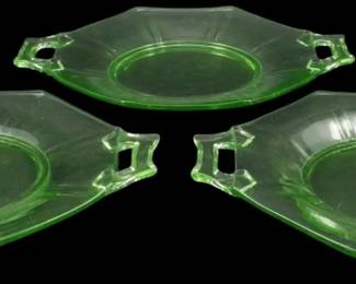 888 - 3 Vtg Uranium Depression Glass Serving Bowls (Description): Three vintage uranium depression glass  serving bowls featuring an elegant octagonal  shape with decorative tab handles. The  translucent green glass exhibits the  characteristic uranium glow typical of this collectible era. Each bowl measures 7 inches  by 9 inches.
