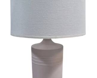 1433 - Robert Abbey Hadrian Matte Woodrose Lamp (Description): White ceramic table lamp featuring a tapered  body with subtle ribbed detailing near the  neck. The lamp rests on a dark bronze patina  circular base and is topped with a  drum-shaped off-white linen shade. Measures 29 inches tall overall. As is  electric/electronic/mechanical item. No  guarantee all components present, untested.