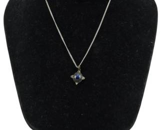 828 - Sterling Silver Necklace with Stone Pendant (Description): Sterling silver necklace featuring a delicate  curb chain with a four-pointed star-shaped  pendant. The pendant is set with a blue  cabochon stone at its center, creating an  elegant celestial design. Weight: 0.14oz.